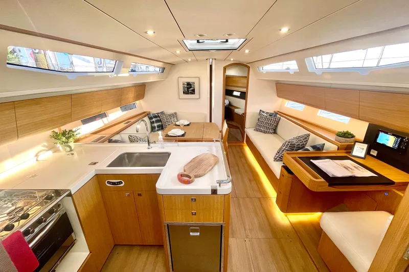 Slide: The Image of Luxurious interior of 2024 J Boats J/45 yacht, featuring modern kitchen and cozy seating area. - 12