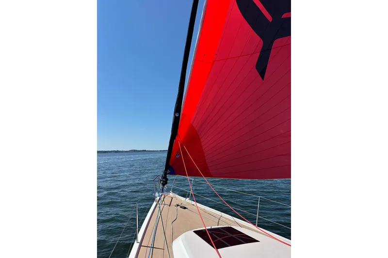 Slide: The Image of 2024 J Boats J/45 sailing with vibrant red sail on open water. - 8