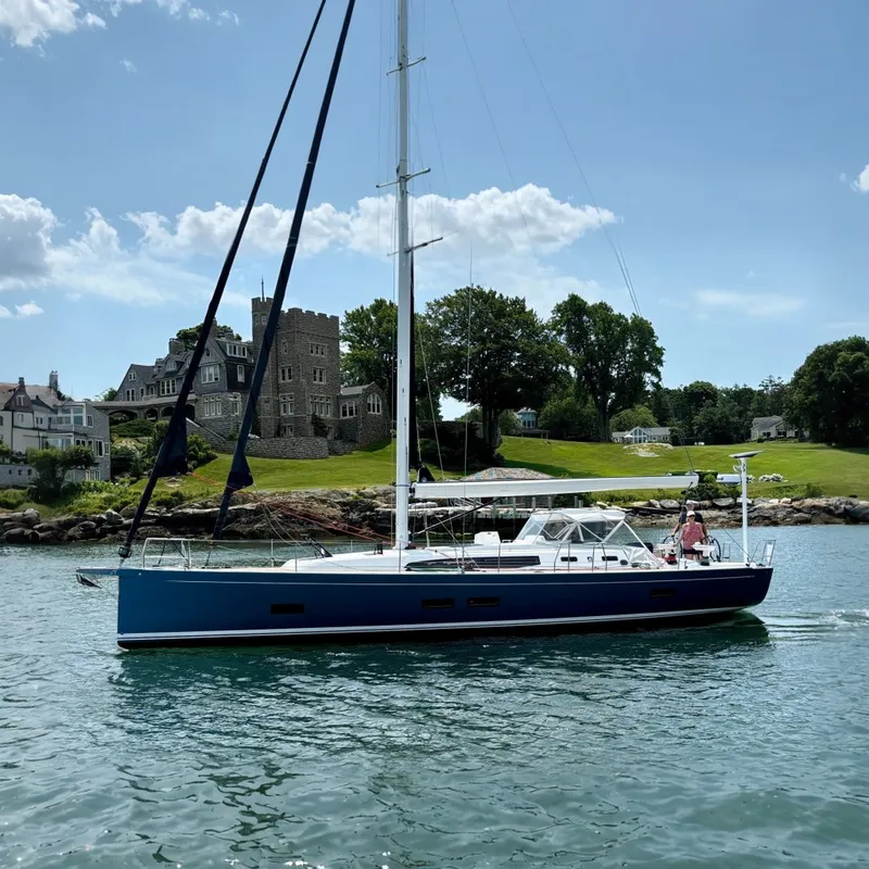 The Image of 2024 J Boats J/45 sailing near a picturesque shoreline with elegant architecture. - 0