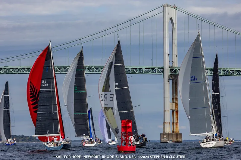Slide: The Image of Sailboats racing near a bridge in Newport, Rhode Island, featuring a 2024 J Boats J/45. - 14