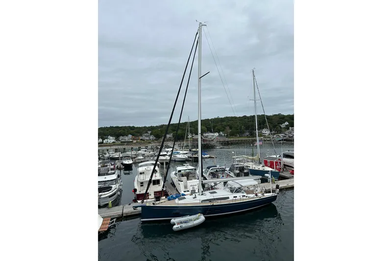 Slide: The Image of 2024 J Boats J/45 sailboat docked in a marina, surrounded by other vessels. - 17
