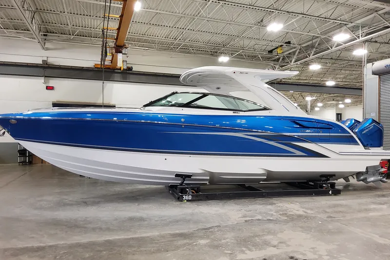 The Image of 2027 Formula 360 Crossover Bowrider OB in a showroom, featuring sleek blue design. - 1