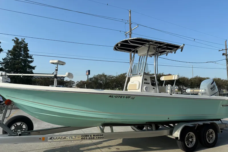 Slide: The Image of 2020 Bulls Bay 2400 XS boat on trailer, light blue hull, outdoor setting. - 7