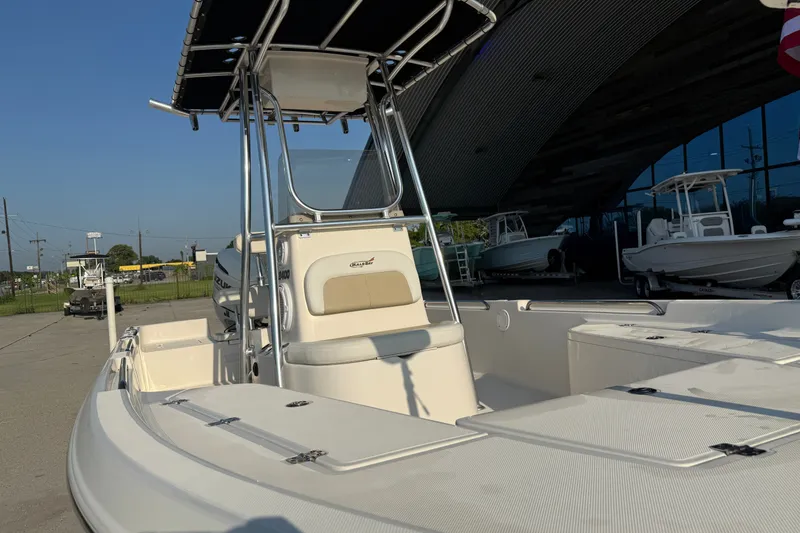 Slide: The Image of 2020 Bulls Bay 2400 XS boat with T-top, docked outdoors under clear sky. - 15