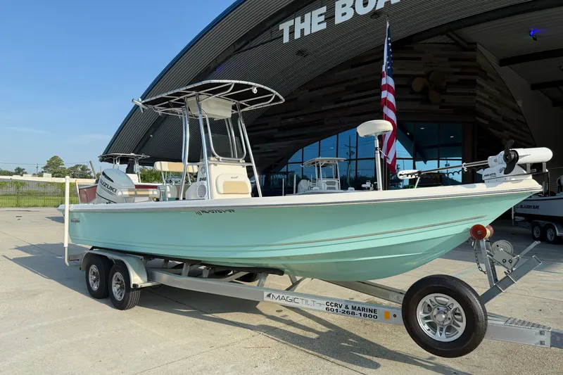 Slide: The Image of 2020 Bulls Bay 2400 XS boat on trailer outside dealership with American flag. - 3