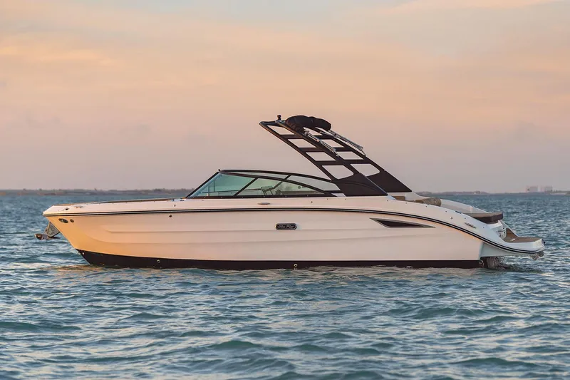 Slide: The Image of Manufacturer Provided Image: 2025 Sea Ray SDX 270 boat on calm water at sunset. - 2