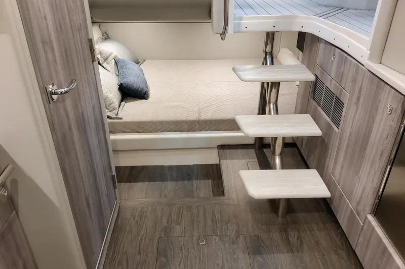 Slide: The Image of Interior of 2027 Formula 400 Super Sport Crossover, featuring modern cabin with bed and steps. - 36