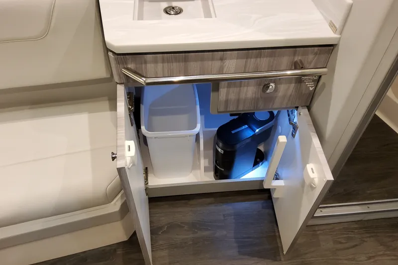 Slide: The Image of 2027 Formula 400 Super Sport Crossover interior cabinet with sink, trash bin, and coffee maker. - 28