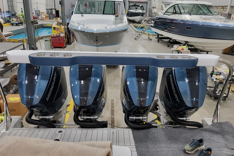 Slide: The Image of 2027 Formula 400 Super Sport Crossover with four Mercury outboard engines in a workshop setting. - 47