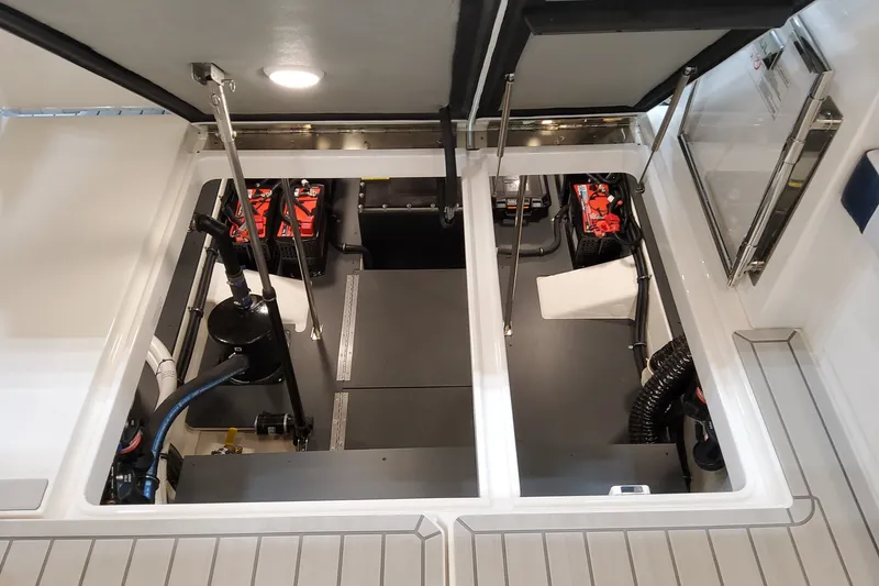 Slide: The Image of Engine compartment of 2027 Formula 400 Super Sport Crossover, showcasing batteries and mechanical components. - 50