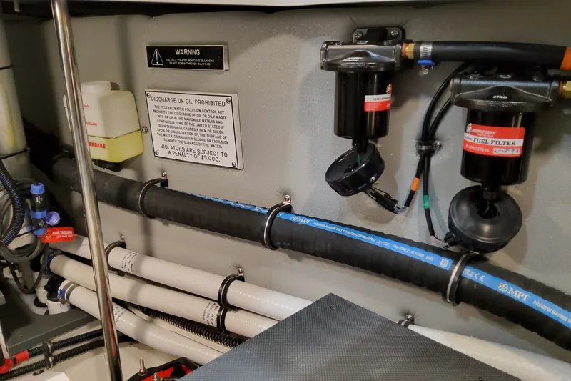 Slide: The Image of Engine room of 2027 Formula 400 Super Sport Crossover with fuel filters and warning signs. - 57