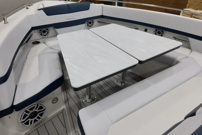 Slide: The Image of 2027 Formula 400 Super Sport Crossover boat interior with sleek seating and dual tables. - 15