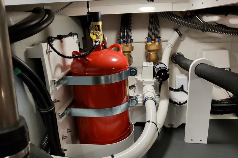 Slide: The Image of Engine room of 2027 Formula 400 Super Sport Crossover with red fire extinguisher and plumbing. - 56