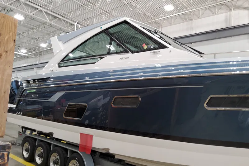 Slide: The Image of 2027 Formula 400 Super Sport Crossover boat in a showroom, side view. - 5