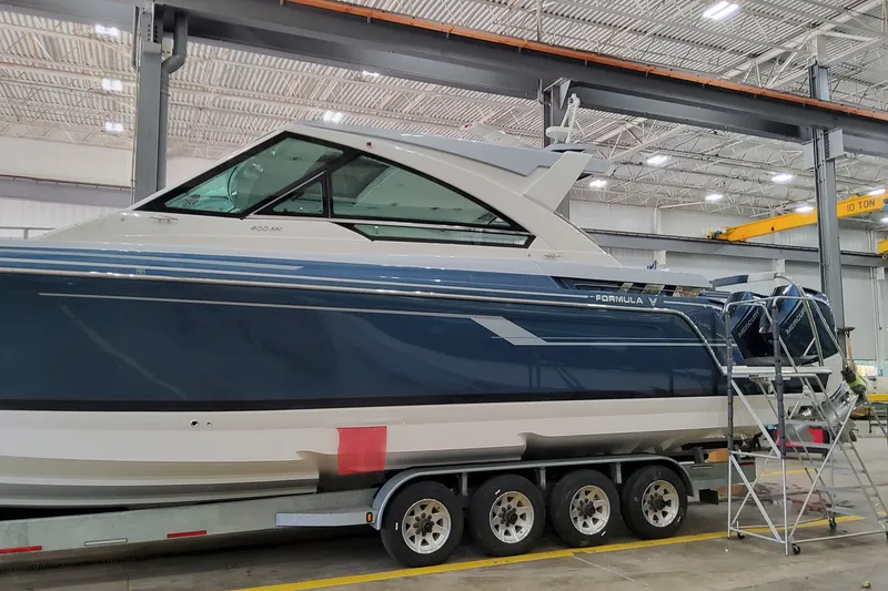 Slide: The Image of 2027 Formula 400 Super Sport Crossover boat in a warehouse on a trailer. - 7