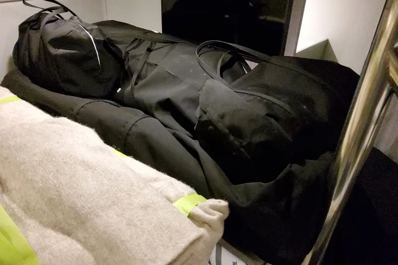 Slide: The Image of Storage area with black bags and beige blanket on a Formula 400 Super Sport Crossover, 2027 model. - 59