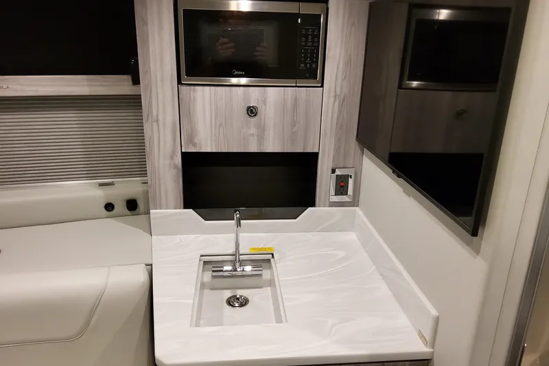 Slide: The Image of Interior of 2027 Formula 400 Super Sport Crossover with modern kitchenette and sleek design. - 27