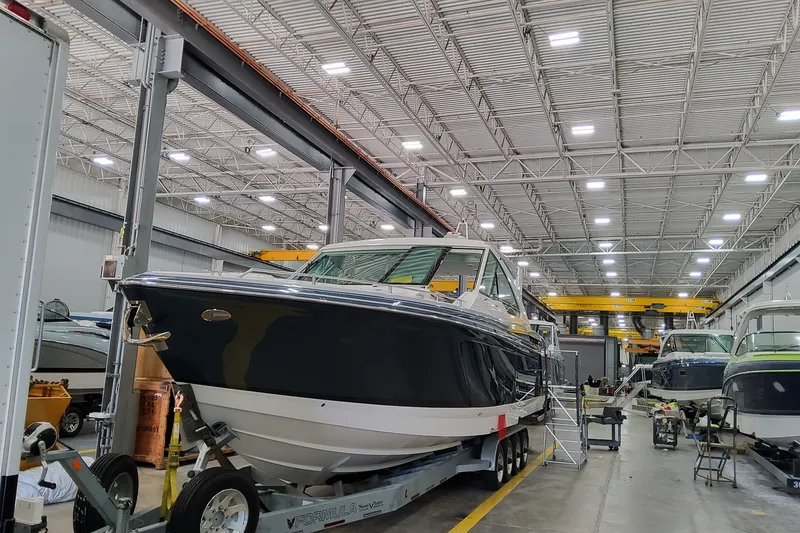 Slide: The Image of 2027 Formula 400 Super Sport Crossover boat in a spacious indoor facility. - 8