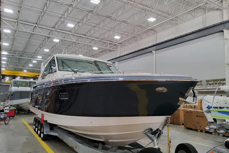 Slide: The Image of 2027 Formula 400 Super Sport Crossover boat in a spacious indoor facility. - 2
