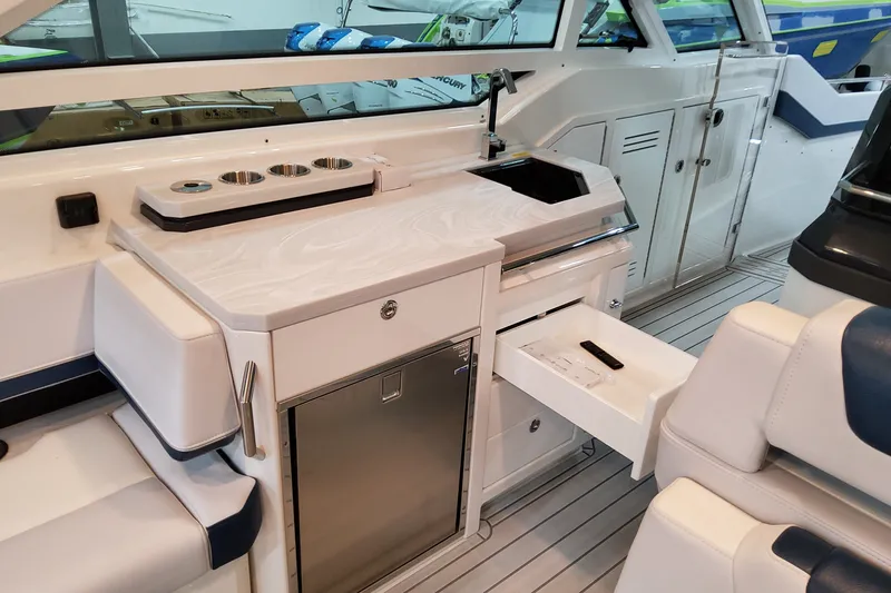 Slide: The Image of Interior of 2027 Formula 400 Super Sport Crossover yacht with sleek kitchenette and seating. - 40