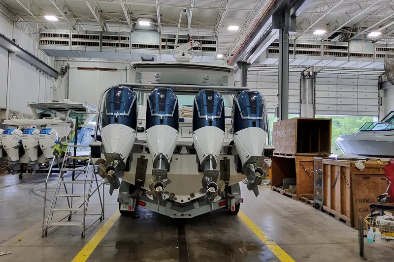 Slide: The Image of 2027 Formula 400 Super Sport Crossover with quad engines in a spacious boatyard. - 3