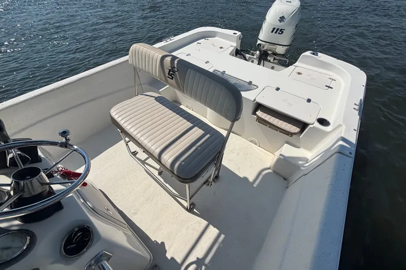 Slide: The Image of 2015 Carolina Skiff 218 DLV boat interior with seating and Suzuki 115 outboard motor. - 11