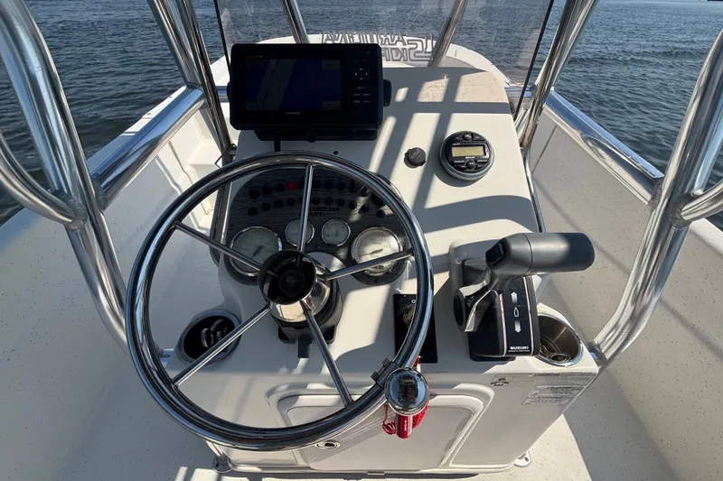 Slide: The Image of 2015 Carolina Skiff 218 DLV boat console with steering wheel and controls. - 12