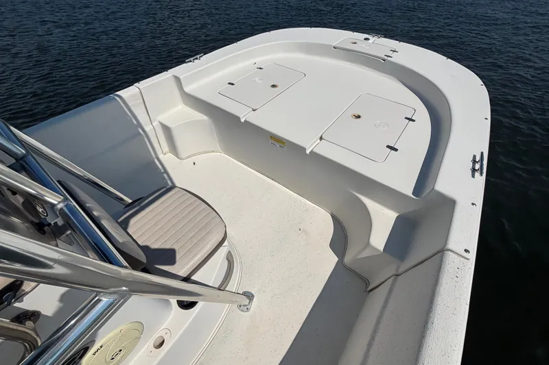 Slide: The Image of 2015 Carolina Skiff 218 DLV boat deck with seating and storage compartments. - 9