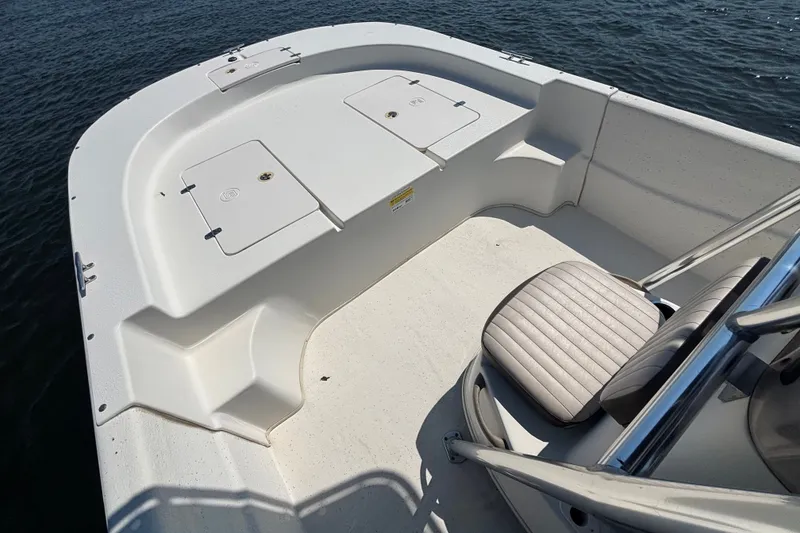 Slide: The Image of 2015 Carolina Skiff 218 DLV boat interior with seating and storage compartments. - 10