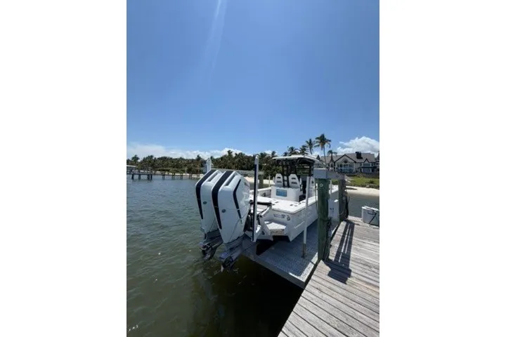 Slide: The Image of 2024 Tidewater 3100 Carolina Bay boat docked by a sunny waterfront. - 15