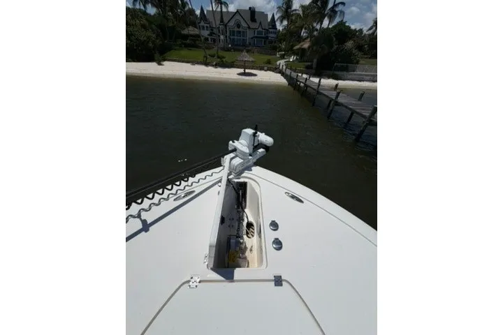 Slide: The Image of 2024 Tidewater 3100 Carolina Bay boat docked near a luxurious waterfront property. - 18