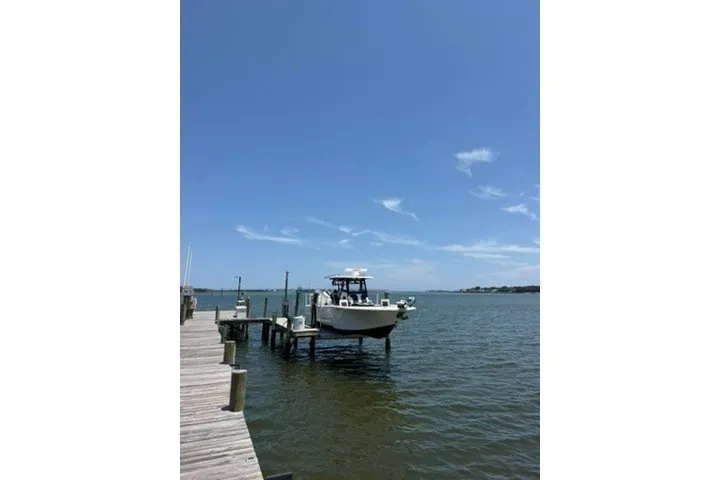 The Image of 2024 Tidewater 3100 Carolina Bay boat docked on a sunny day. - 0