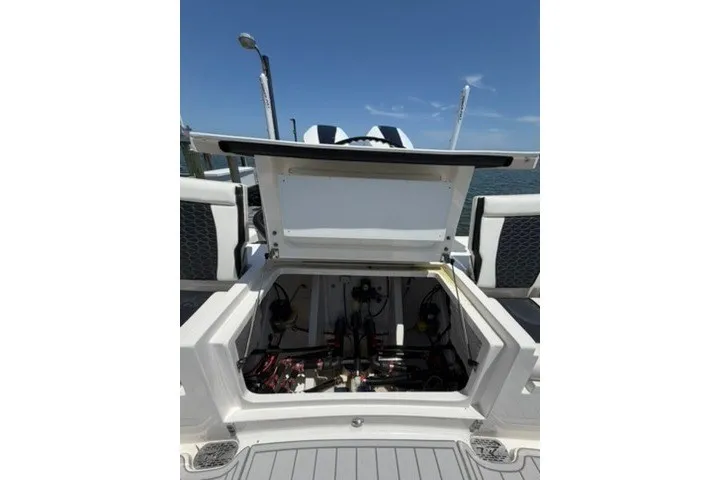 Slide: The Image of 2024 Tidewater 3100 Carolina Bay boat with open storage compartment, showcasing internal components. - 13