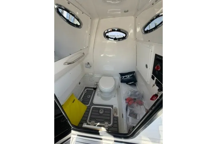 Slide: The Image of 2024 Tidewater 3100 Carolina Bay boat interior with toilet and storage compartments. - 27