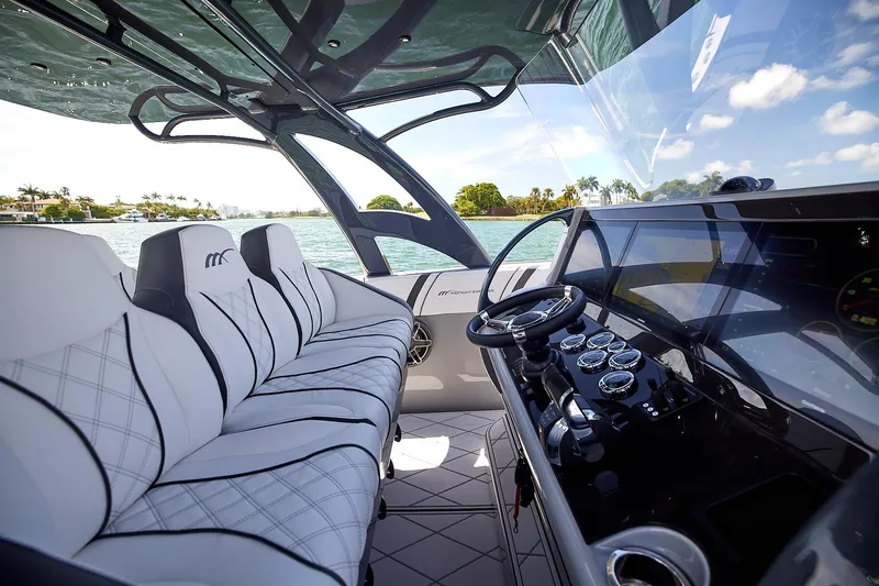 Slide: The Image of Luxurious interior of 2022 Midnight Express 43 Open boat with modern dashboard and seating. - 26