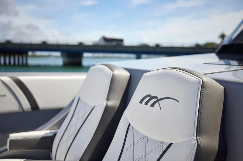 Slide: The Image of Luxury seating on 2022 Midnight Express 43 Open boat with bridge in background. - 32