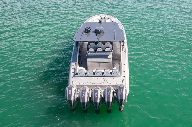 Slide: The Image of 2022 Midnight Express 43 Open boat with five powerful outboard engines on turquoise water. - 15
