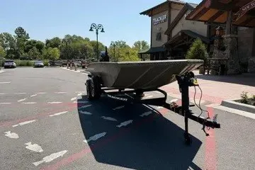 The Image of 2026 Tracker Grizzly 1756 T Marsh boat on trailer in parking lot. - 0