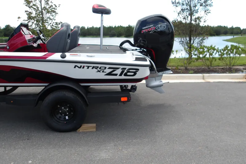 Slide: The Image of 2027 Nitro Z18 XL Pro boat with Mercury Pro XS engine by a lake. - 3