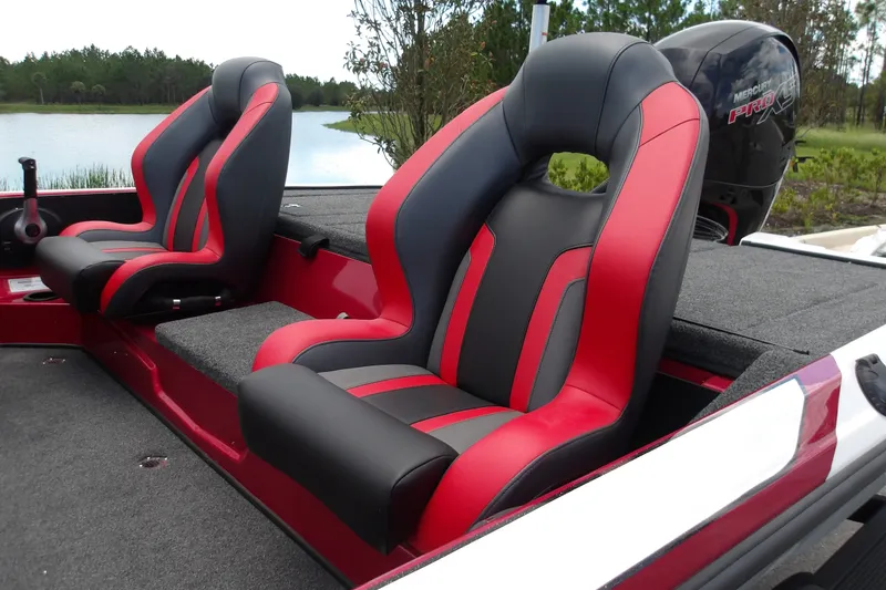 Slide: The Image of Red and black seats in a 2027 Nitro Z18 XL Pro boat by a lake. - 18