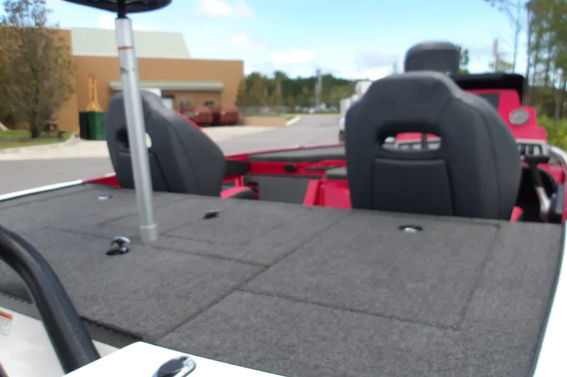 Slide: The Image of 2027 Nitro Z18 XL Pro boat interior with seating and deck, parked outdoors. - 7