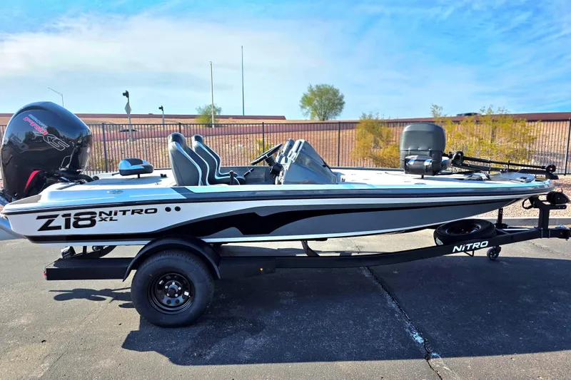 The Image of 2027 Nitro Z18 XL boat on trailer, parked outdoors under clear sky. - 0