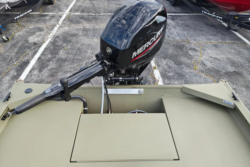 Slide: The Image of 2027 Tracker Grizzly 1654 T Sportsman boat with Mercury outboard motor in parking lot. - 24