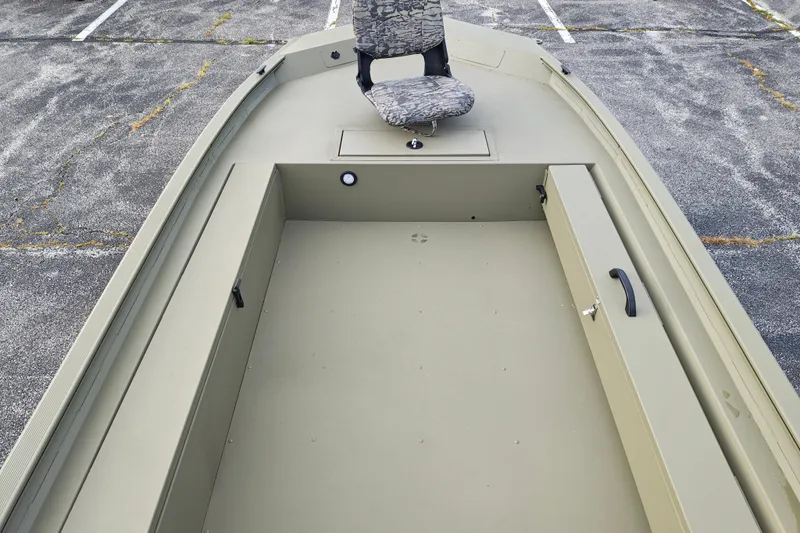 Slide: The Image of 2027 Tracker Grizzly 1654 T Sportsman boat interior with seating and storage compartments. - 26