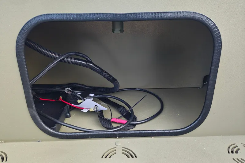 Slide: The Image of Storage compartment with wiring in 2027 Tracker Grizzly 1654 T Sportsman boat. - 21