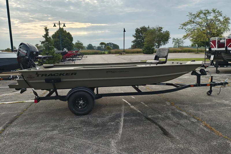 The Image of 2027 Tracker Grizzly 1654 T Sportsman boat on trailer in parking lot. - 0