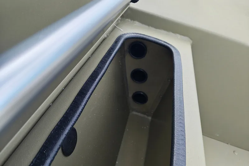 Slide: The Image of Storage compartment of 2027 Tracker Grizzly 1654 T Sportsman boat, featuring multiple rod holders. - 19