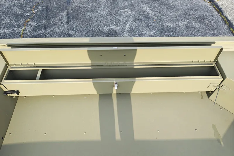 Slide: The Image of Open storage compartment of 2027 Tracker Grizzly 1654 T Sportsman boat. - 15
