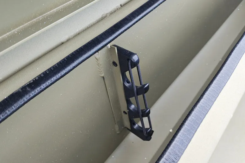 Slide: The Image of Interior detail of 2027 Tracker Grizzly 1654 T Sportsman boat, featuring a rod holder. - 18