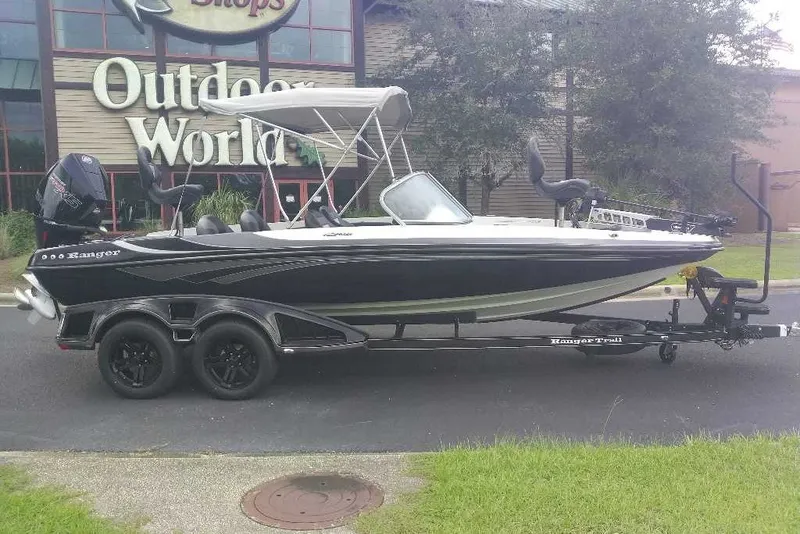 The Image of 2026 Ranger 212LS boat on trailer outside Outdoor World store. - 0